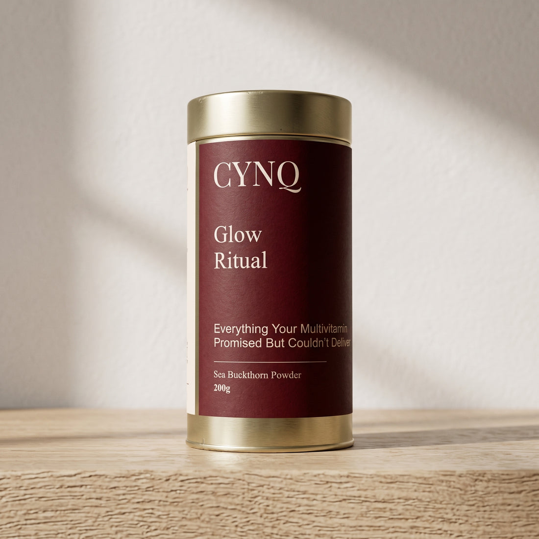 Glow Ritual sea buckthorn powder tin, front view, on an oak shelf in soft window light