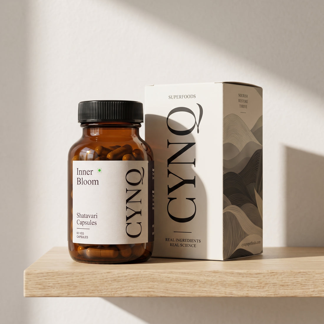 Inner Bloom capsule bottle beside the CYNQ outer box on an oak shelf