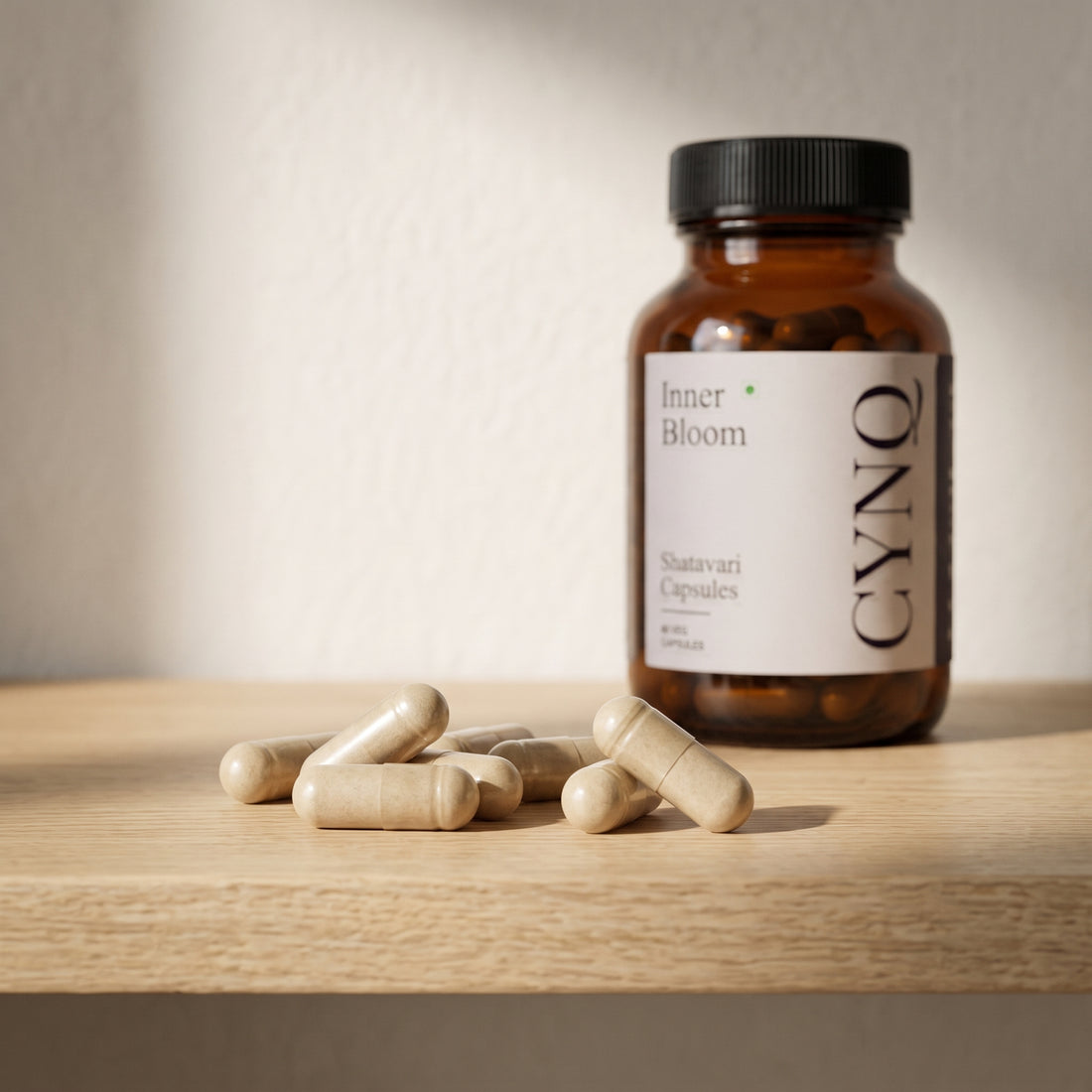 Shatavari capsules on an oak shelf with an Inner Bloom bottle behind